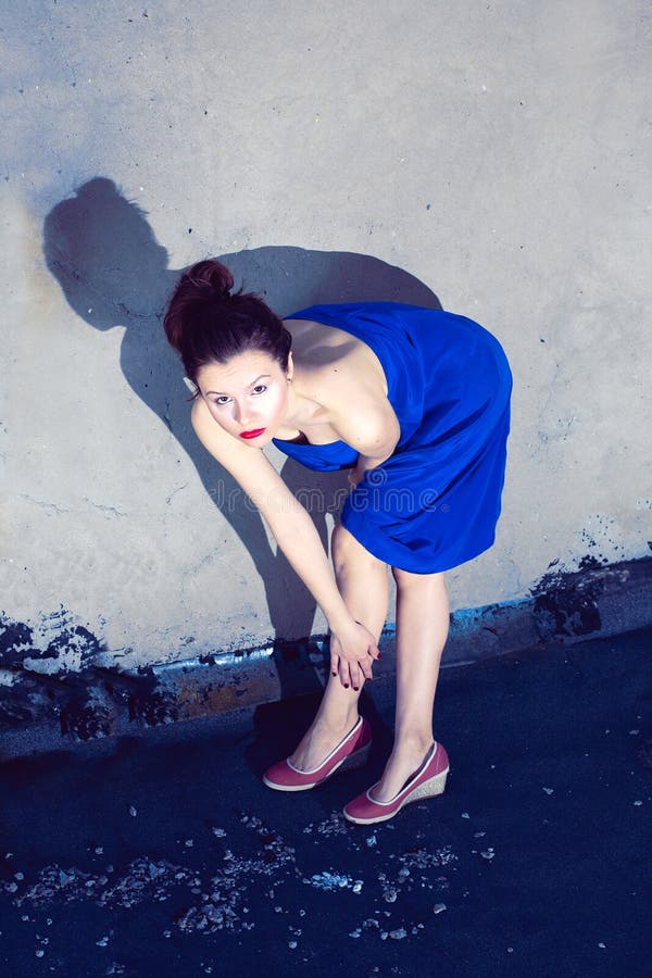 Young slim woman in blue dress