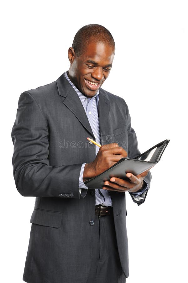 Young smiling black businessman taking notes