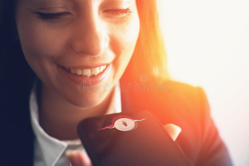 Young smiling business woman using smart phone voice message recognition or vocal digital AI assistant