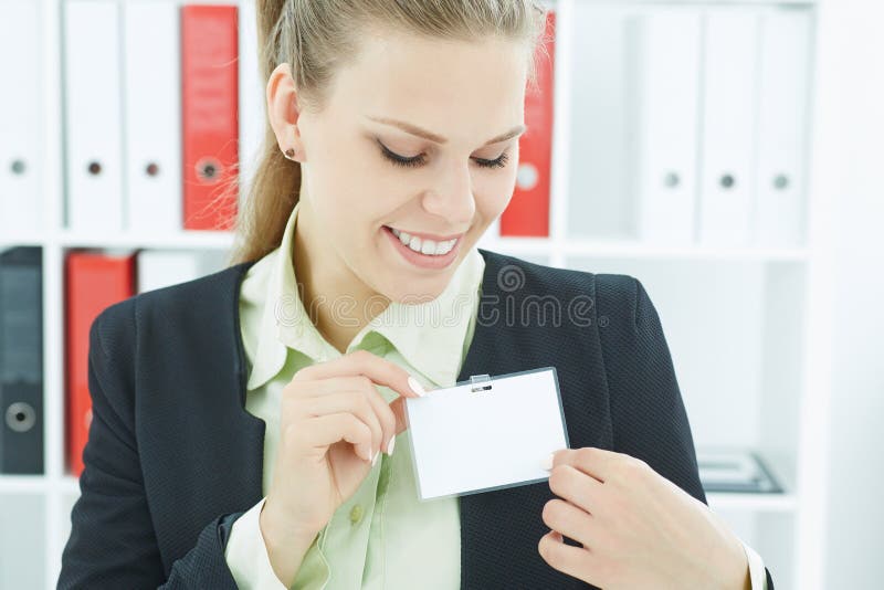 Young smiling business woman wearing blank badge. Name tag on chest. Person identity label. Business card mockup.