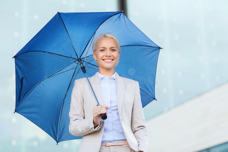 Young smiling businesswoman with umbrella outdoors. Business, bad weather and people and concept - young smiling businesswoman with umbrella outdoors stock image Young smiling businesswoman with umbrella outdoors. Business, bad weather and people and concept - young smiling businesswoman with umbrella outdoors stock image