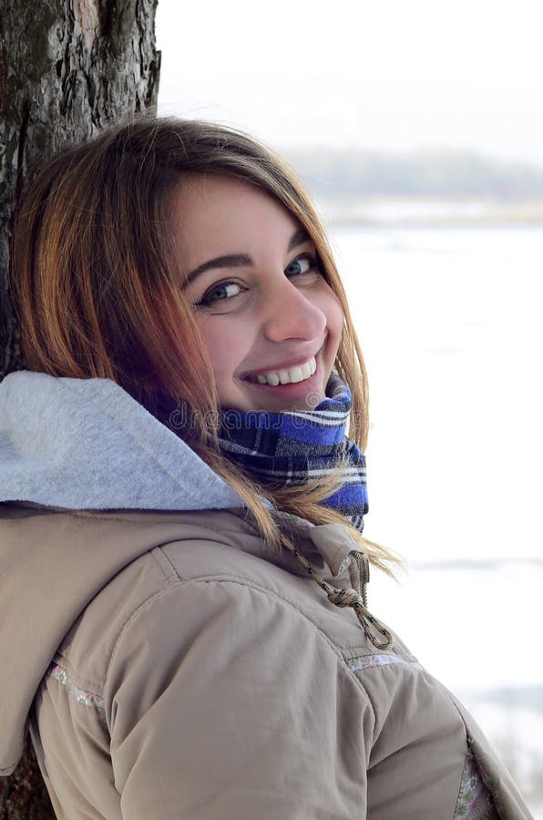 A young and smiling Caucasian girl looks around the horizon line between the sky and the frozen lake royalty free stock images A young and smiling Caucasian girl looks around the horizon line between the sky and the frozen lake royalty free stock images