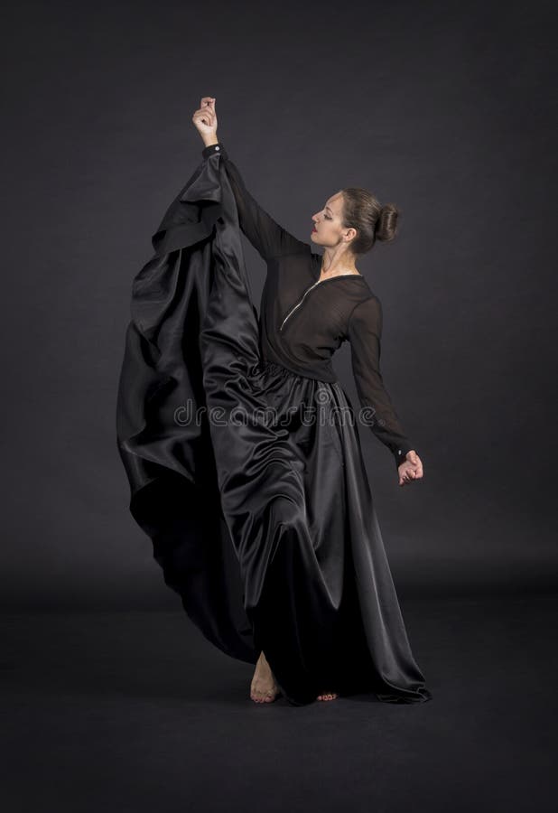 A Young,smiling Girl in Black Suit Dancing Modern Choreography Stock ...