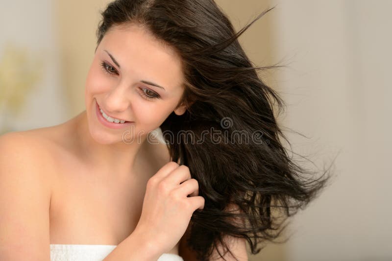 Young smiling girl blow drying her hair royalty free stock image Young smiling girl blow drying her hair royalty free stock image