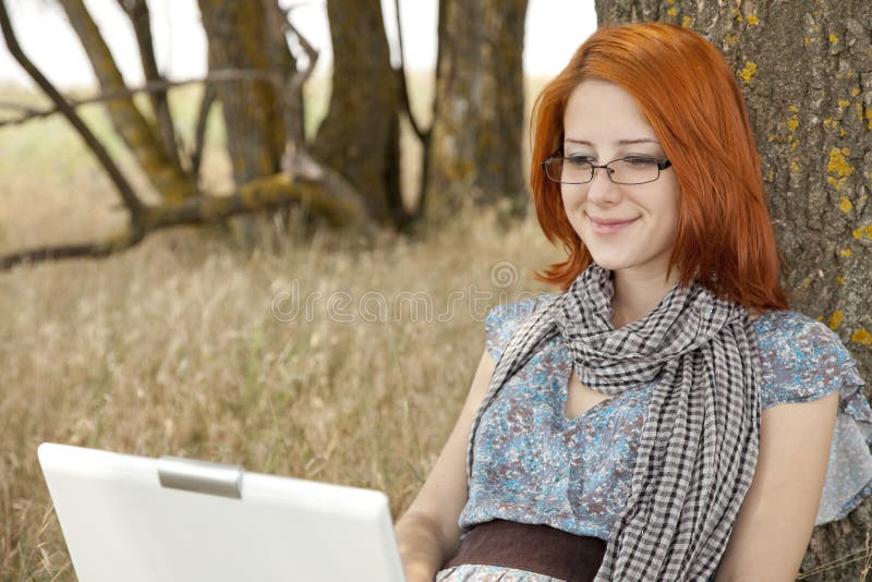 Young smiling girl in glasses and notebook