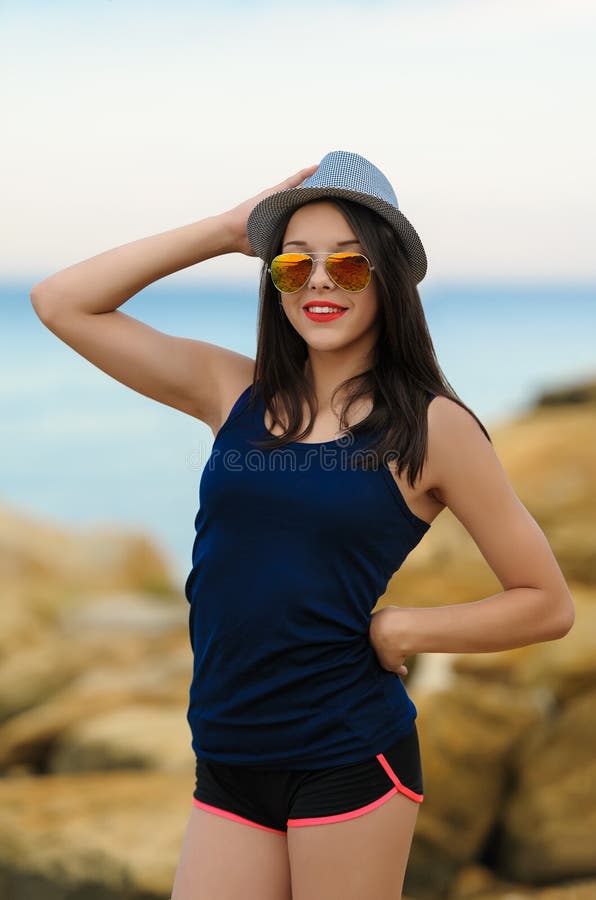 Young smiling girl in grey hat and sun glasses royalty free stock images Young smiling girl in grey hat and sun glasses royalty free stock images