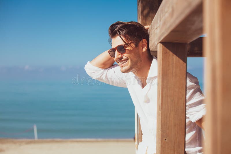 Young smiling happy man on beach vacation