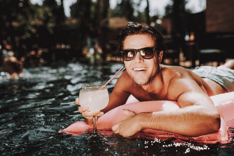 Young Smiling Man in Sunglasses on Air Mattress royalty free stock image Young Smiling Man in Sunglasses on Air Mattress royalty free stock image