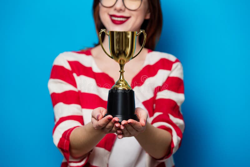 Young smiling woman with cup trophy