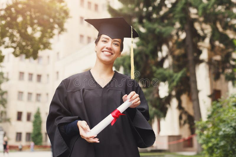Happy young woman on her graduation day. royalty free stock photography Happy young woman on her graduation day. royalty free stock photography