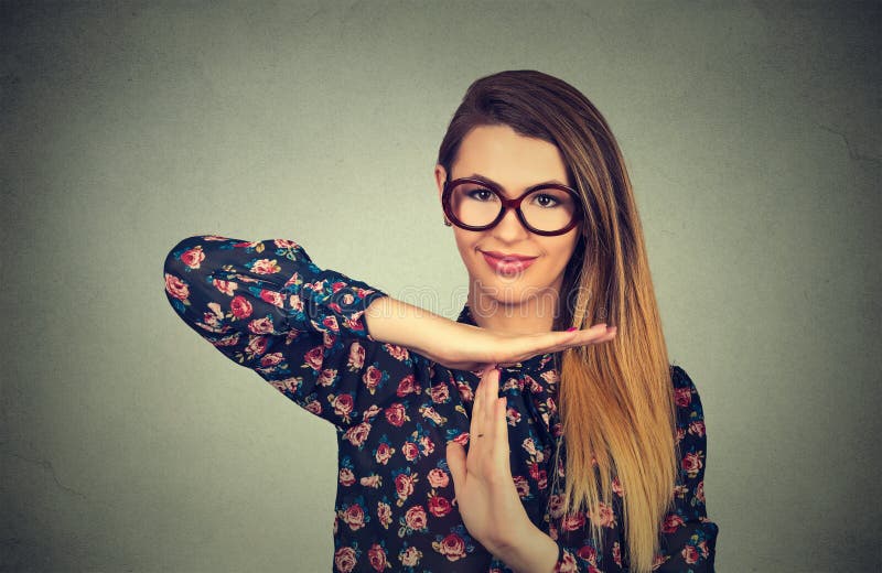 Young smiling woman showing time out