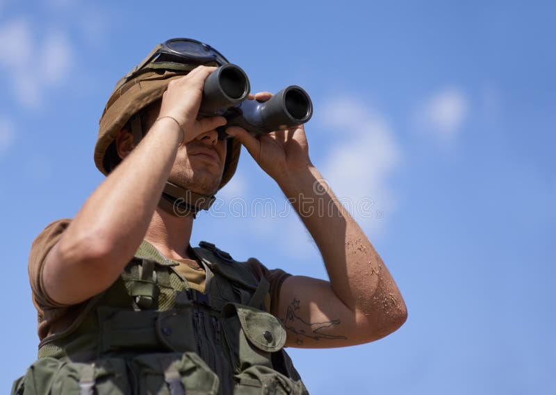 On the Lookout. a Young Soldier Looking through His Binoculars. Stock