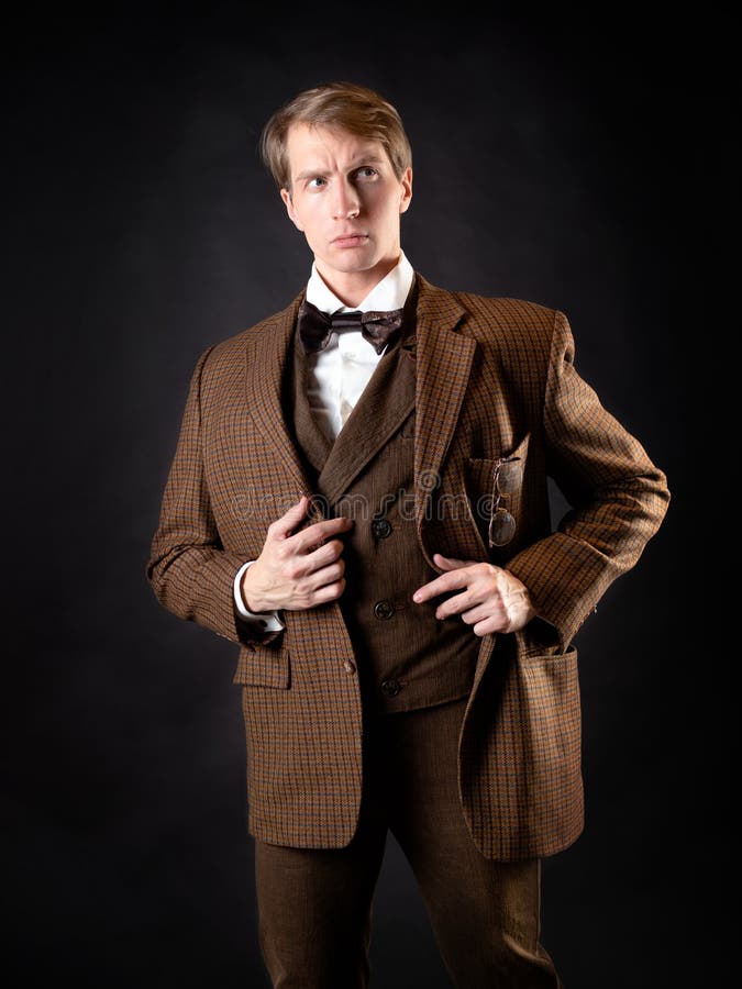 A young, solid man in the image of a Victorian scientist,. A university teacher or a natural scientist. Vintage retro suit, young attractive man in a vest and stock photos A young, solid man in the image of a Victorian scientist,. A university teacher or a natural scientist. Vintage retro suit, young attractive man in a vest and stock photos