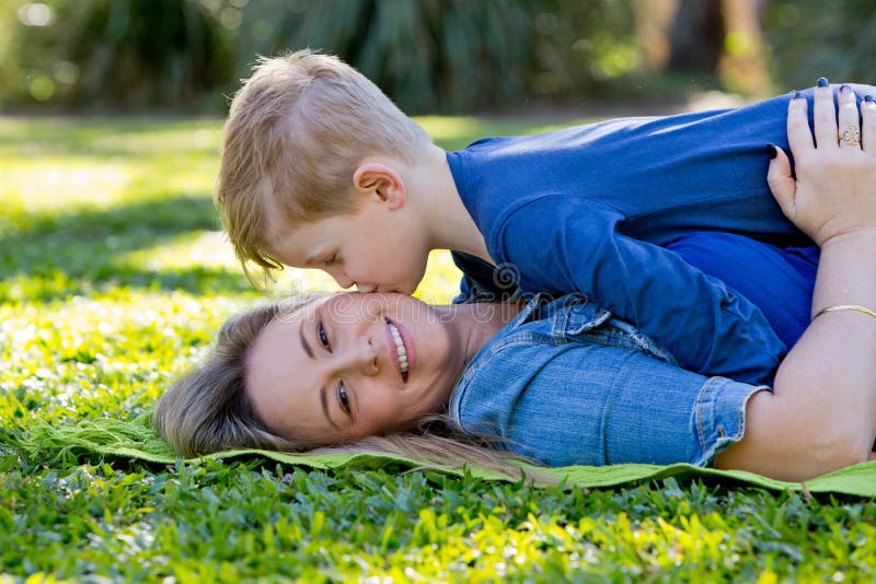 Mother Kissing Young Son on Cheek Whilst Playing Together on