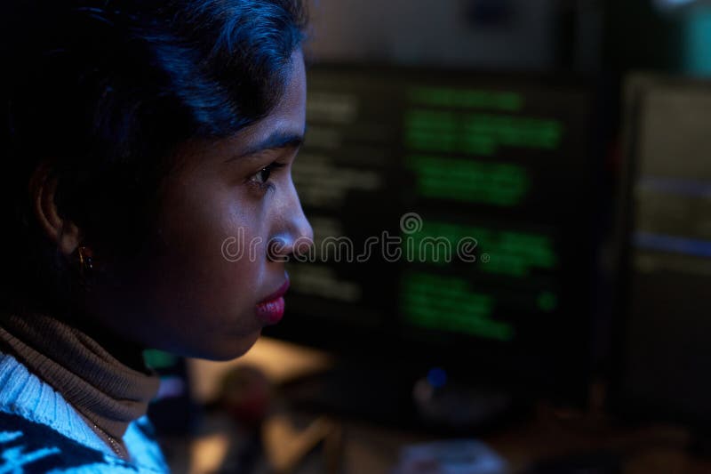 Young South Asian Woman Concentrating While Working on Computer Screen stock photography