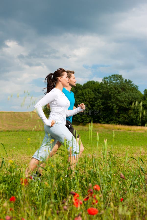Young sportive couple is jogging outside royalty free stock photo Young sportive couple is jogging outside royalty free stock photo