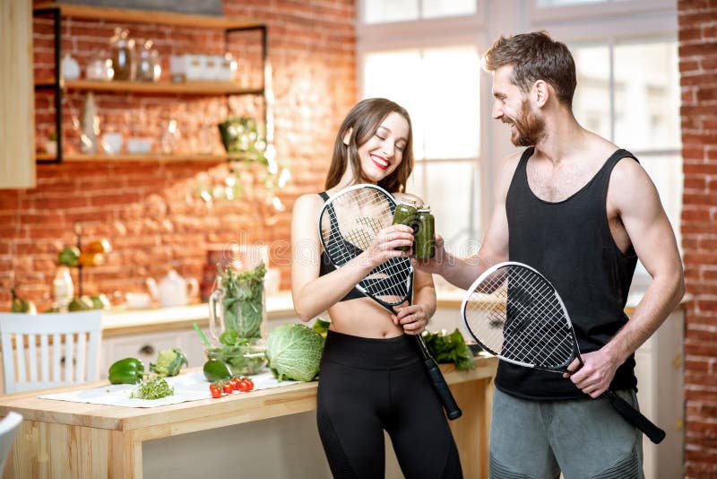 Sports couple eating healthy food on the kitchen at home royalty free stock photos Sports couple eating healthy food on the kitchen at home royalty free stock photos