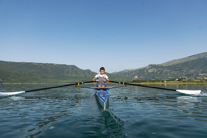 The Young Sportsman is Rowing on the Racing Kayak Stock Photo Image