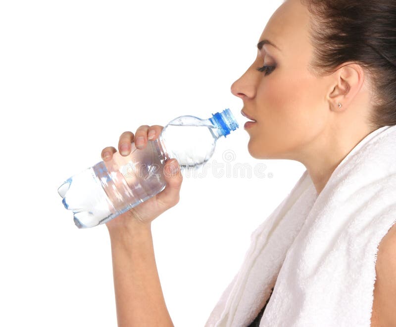 A young and sporty female is drinking water