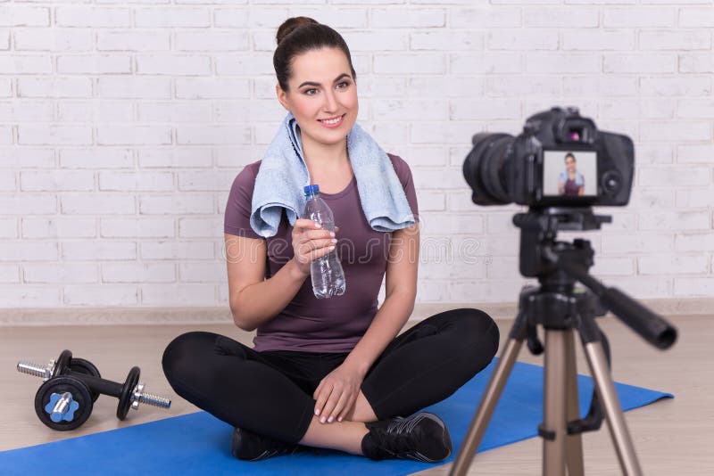 Young sporty woman blogger making new video at home