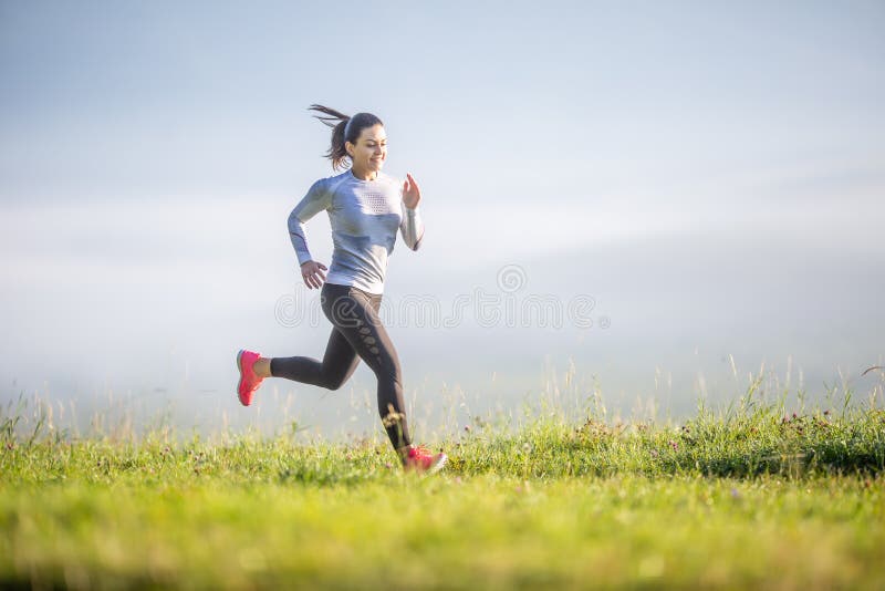 Young sporty woman running in nature. Morning training sportswoman