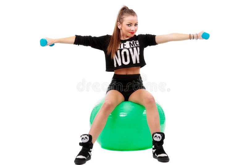 Young sporty woman sitting on fitball with dumbbells on white ba royalty free stock image Young sporty woman sitting on fitball with dumbbells on white ba royalty free stock image