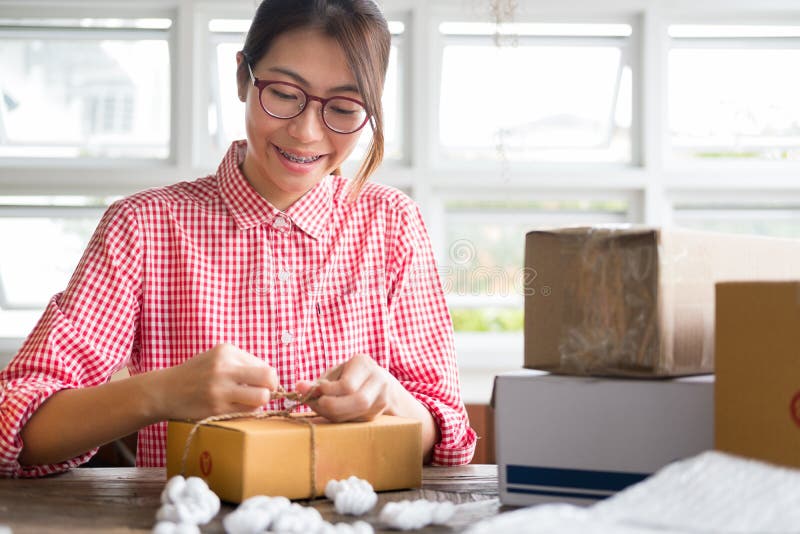 Start Up Small Business Owner Packing Cardboard Box at Workplace Stock