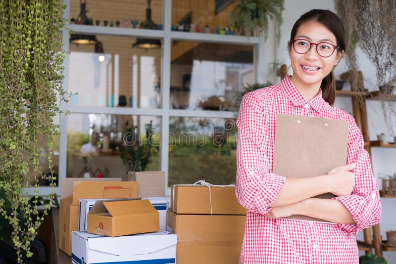 Start Up Small Business Owner Holding Clipboard At Workplace. Fr Stock