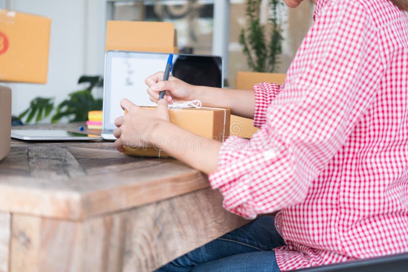 Start Up Small Business Owner Writing Address On Cardboard Box A Stock