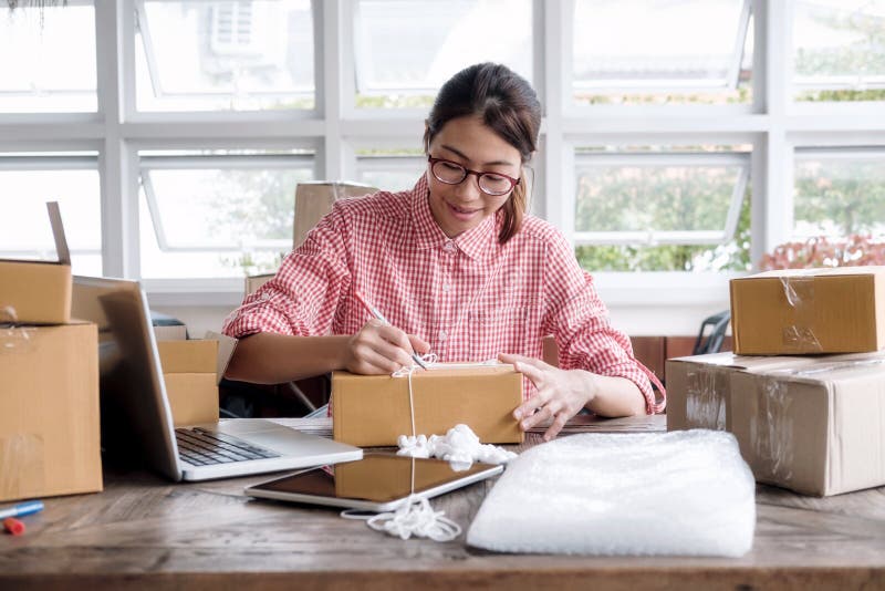 Young startup entrepreneur small business owner working at home, packaging and delivery situation. stock images Young startup entrepreneur small business owner working at home, packaging and delivery situation. stock images