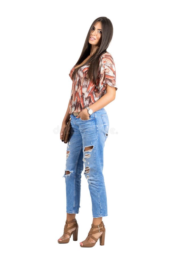 Young straight hair Indian woman holding handbag posing at camera with hand in pocket. stock photos Young straight hair Indian woman holding handbag posing at camera with hand in pocket. stock photos