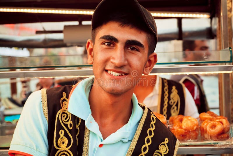 Young street food vendor in the traditional Turkish clothes stock photo