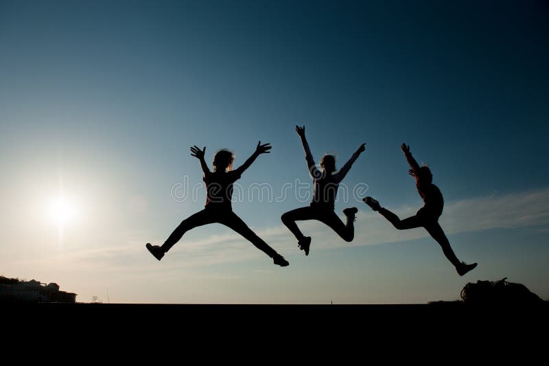 Young street teenager three active kids jumping on urban sunset street royalty free stock photos