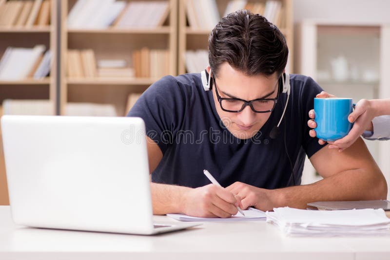 The young student drinking coffee from cup