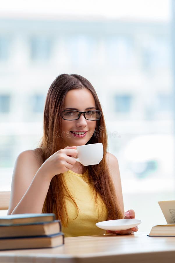 The young student drinking coffee while sudying