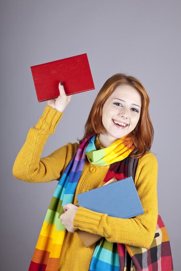 Young student girl with books.