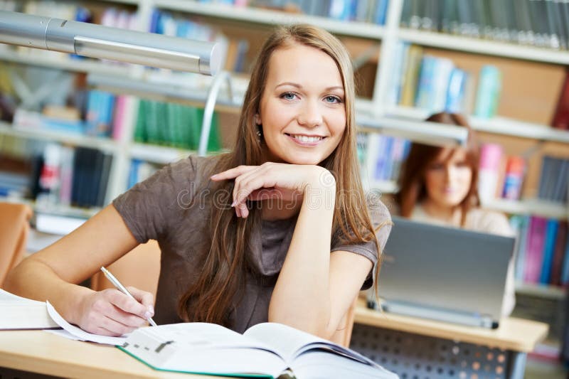 Young student girl working with book at library royalty free stock image