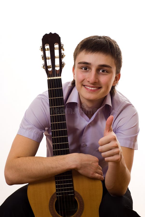 Young student with a guitar on a white