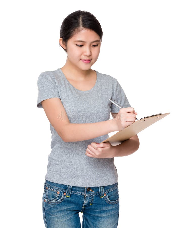 Young student jot down the information on clipboard