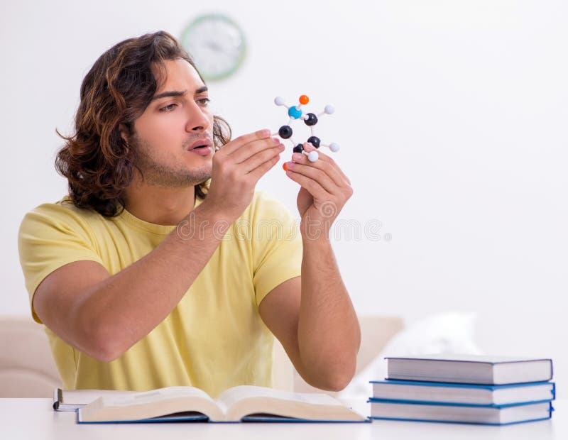 Young male student preparing for exams at home stock image
