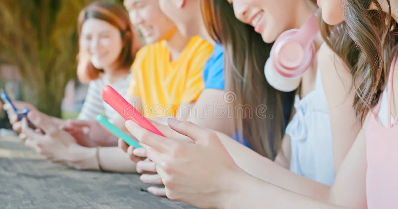Young students use smartphone stock photos