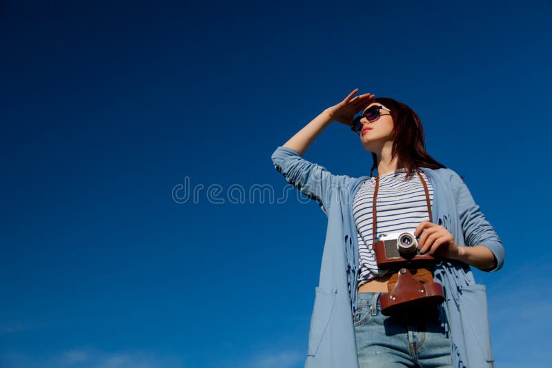 Redhead girl in modern clothes with camera royalty free stock image Redhead girl in modern clothes with camera royalty free stock image