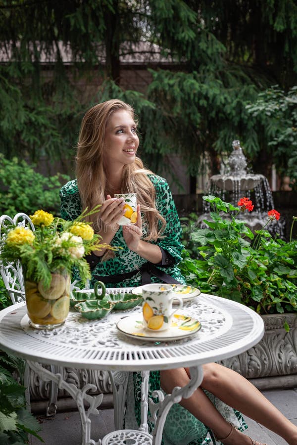 Young stylish woman holding a cup in the