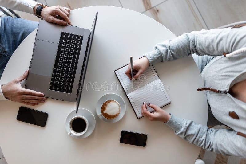 Young successful business executive sits with a laptop and interviews a girl manager in an office. Business meeting men and women royalty free stock photo Young successful business executive sits with a laptop and interviews a girl manager in an office. Business meeting men and women royalty free stock photo