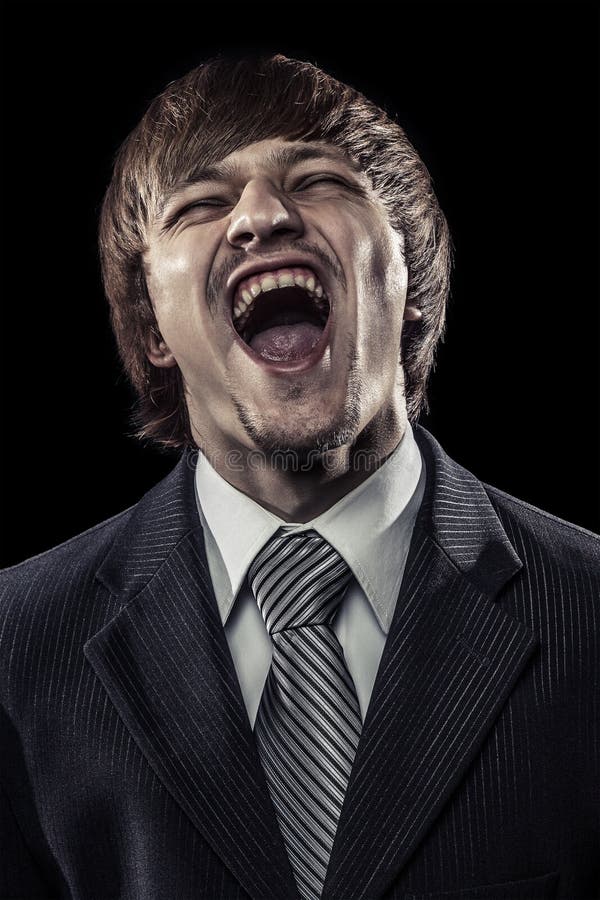 Young successful businessman laughing hard