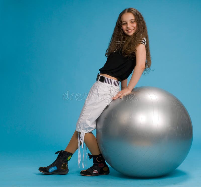 Young sweet girl with a big grey ball