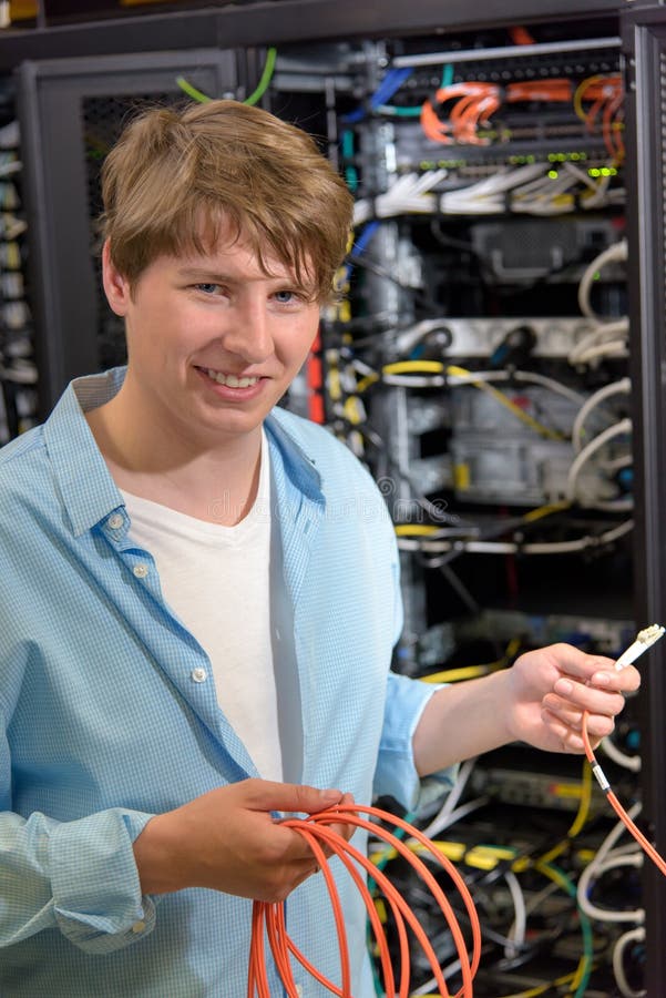 Young Technician Holding Optical Cable in Datacenter Stock Image