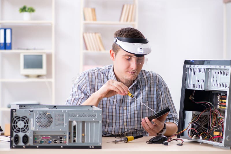The Young Technician Repairing Computer in Stock Photo Image