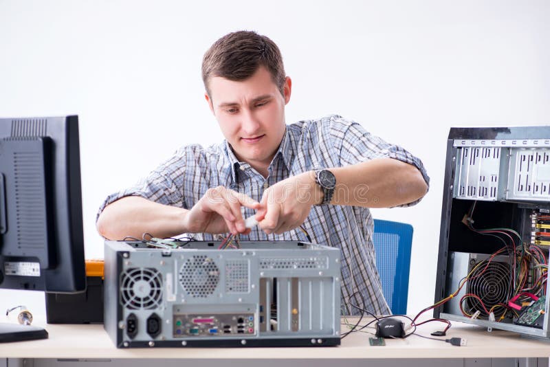 The Young Technician Repairing Computer in Stock Photo Image
