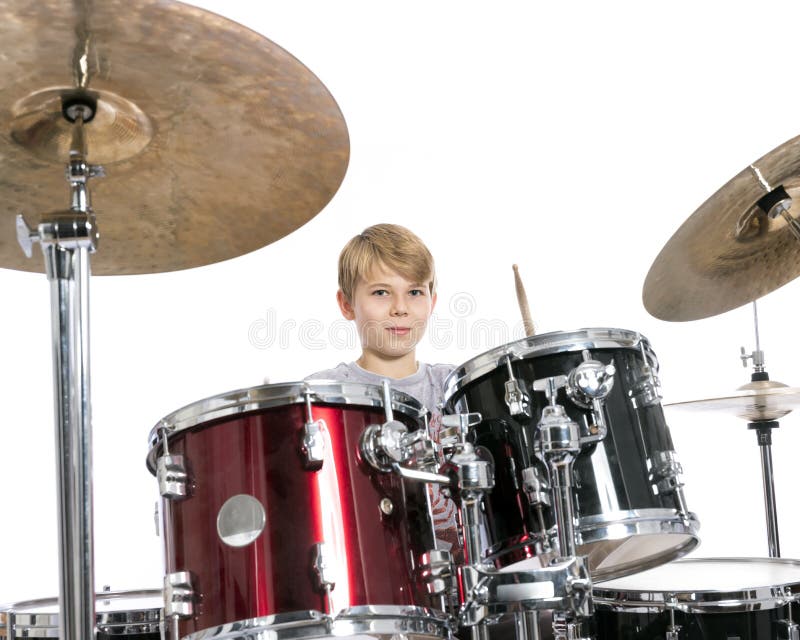 young teen boy plays the drums in studio against white background stock image young teen boy plays the drums in studio against white background stock image